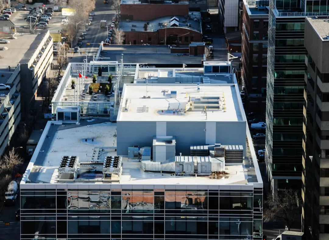 Aerial view of a flat commercial rooftop, the kind of building a property manager evaluates when vetting a roofing vendor.