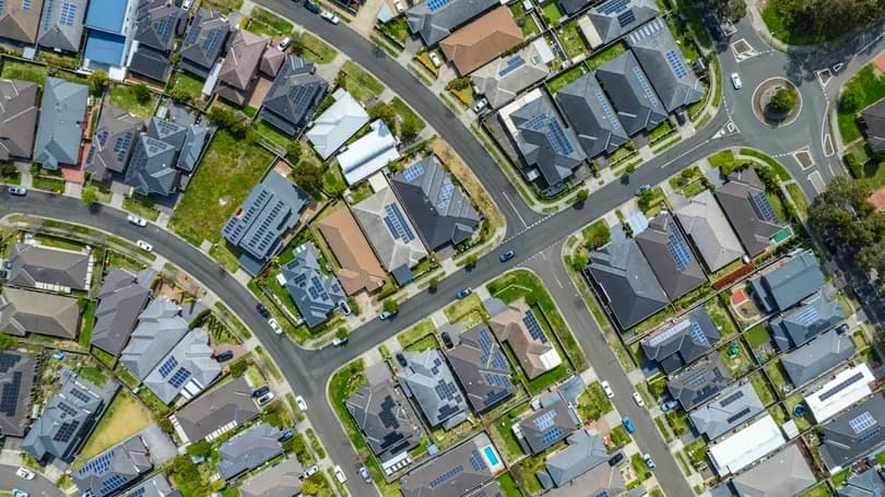 Aerial view of suburban rooftops in a residential neighborhood at street level