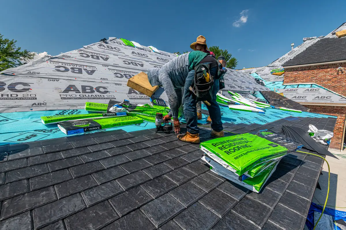 A roofing crew mid-installation on a residential roof, the kind of visible work on a street a postcard mailing can target.