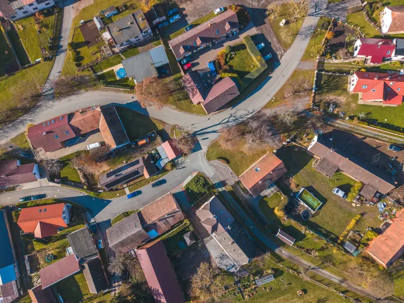 Aerial view of red residential rooftops across a neighborhood